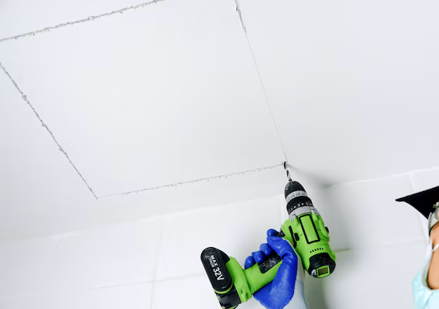 man-holding-electric-drill-his-hand-drilling-holes-install-service-port-ceiling_483511-4707